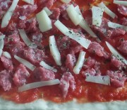 Pizza fatta in casa con salsiccia e fontina